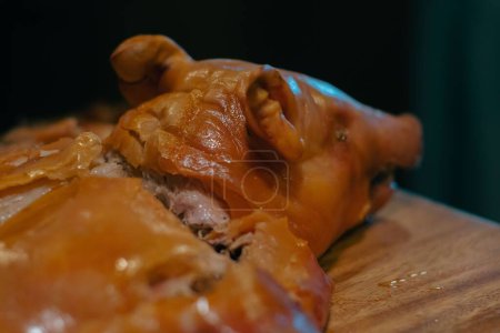Foto de Un primer plano de un cerdo español asado acostado sobre la mesa de madera - Imagen libre de derechos
