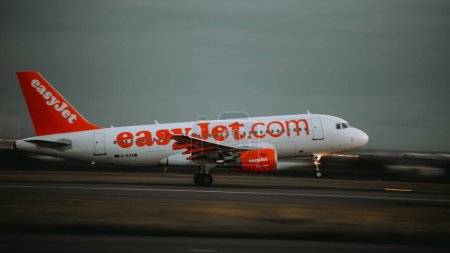 Photo for An EasyJet airplane a320 taking off at sunset in John Lennon Airport, Liverpool, United Kingdom - Royalty Free Image