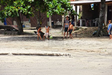 Photo for A group of Kids playing soccer on the beach of IlhaBella in Brazil - Royalty Free Image