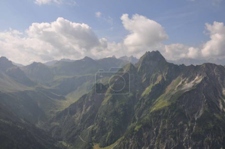 Photo for A mountain range, with rugged rocky mountains and steep slopes covered by grass - Royalty Free Image