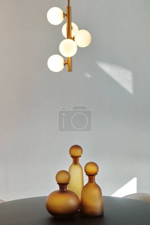 Photo for A vertical shot of glass yellow bottles for alcoholic beverages isolated on a white background - Royalty Free Image