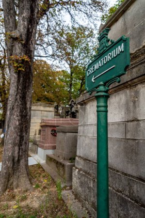 Photo for A vertical shot of a green board reading 'Crematorium' in the Pere Lachaise Cemetery in Paris, France - Royalty Free Image