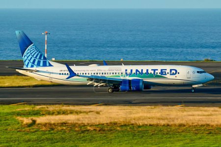 Photo for The United Airlines Boeing airplane arriving in Ponta Delgada Azores with the ocean in the background - Royalty Free Image