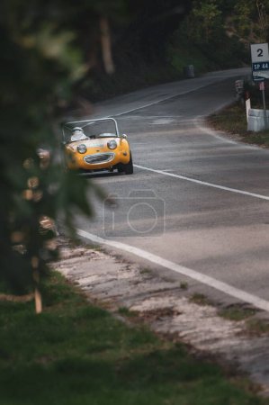 Photo for A yellow car set up during an uphill speed race of the Italian championship in Pesaro - Royalty Free Image