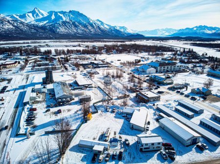 An aerial shot of industrial buildings and cars parked nearby in the city of Palmer, Alaska
