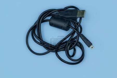 Photo for A usb and mini usb cable isolated on blue background - Royalty Free Image