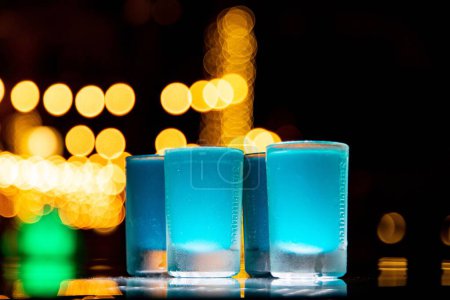 Photo for The blue cocktails on a table in a bar with bokeh lights on the background - Royalty Free Image