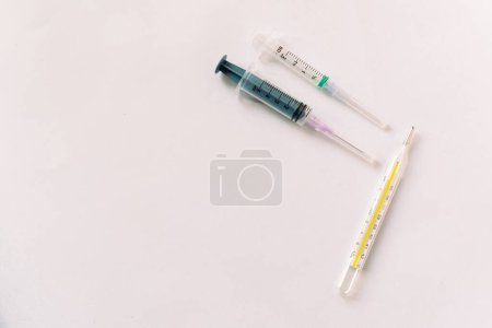 Téléchargez les photos : Thermomètre, seringue, concept de rhume, de covide ou de grippe automnale - en image libre de droit