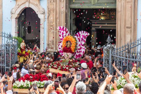 Photo for Salvador, Bahia, Brazil - December 04, 2022: Crowd of Catholics saluting the image of Santa Barbara leaving the church. Pelourinho, Salvador, Bahia. - Royalty Free Image