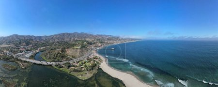 Photo for An aerial panoramic shot of the beach with the waves of water crashing on the shore, Los angeles, Malibu - Royalty Free Image