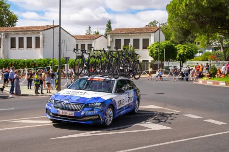 Photo for The vehicles of the cyclists carrying many bicycles on the roof during the cycling tour of Spain - Royalty Free Image