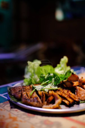 Photo for A vertical closeup shot of grilled Thai meat at a restaurant - Royalty Free Image