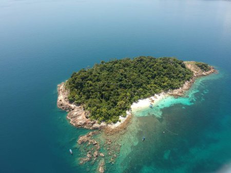 Photo for An aerial shot of the Perhentian Islands with green trees surrounded by the calm sea on a sunny day - Royalty Free Image