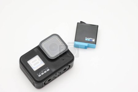 Photo for An action camera from the manufacturer Gopro with a battery on white background - Royalty Free Image
