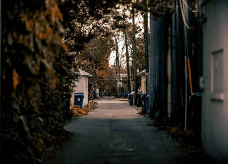 Photo for A narrow road in the urban area with recycle bins on the street - Royalty Free Image