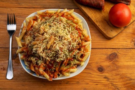 Photo for Fresh tasty Italian pasta penne with tomato and cheese on a wooden table - Royalty Free Image