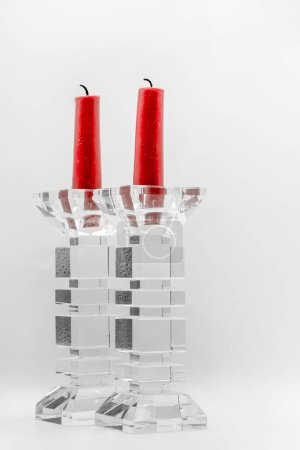 Photo for A closeup of two red candles in clear glass candelabras - Royalty Free Image