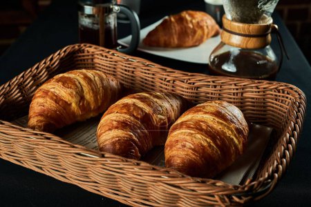 Photo for A closeup shot of some croissants in a brown basket - Royalty Free Image