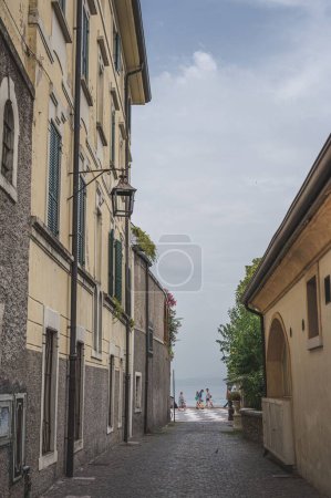 Photo for A vertical shot of a street leading to the Garda lake - Royalty Free Image