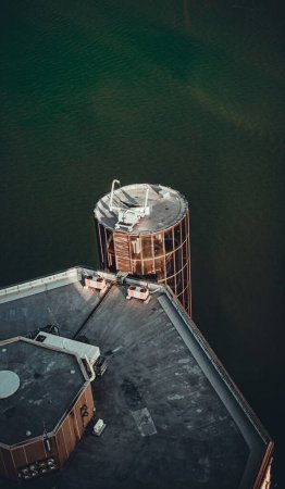 Téléchargez les photos : Plan vertical d'un bâtiment avec une tour ronde en verre au bord de la mer - en image libre de droit