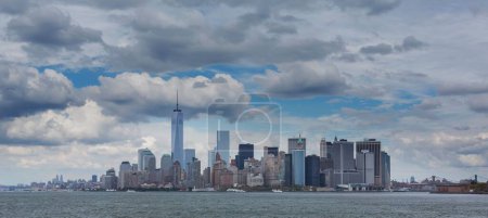 Photo for A panoramic shot of the city of New York during the day with big fluffy clouds in the sky - Royalty Free Image
