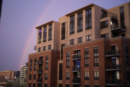 Photo for A residential building against the background of the sky with a rainbow after the rain. Madison, USA. - Royalty Free Image