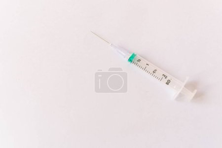 Photo for Syringe on a white table prepared for injection in hospital - Royalty Free Image