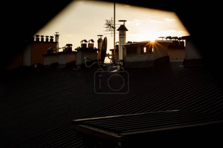 Photo for A Roof with chimneys during sunset with gray sky - Royalty Free Image