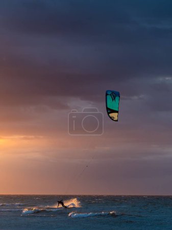 Téléchargez les photos : Un cerf-volant surfeur sur la mer du Nord pendant le coucher du soleil - en image libre de droit