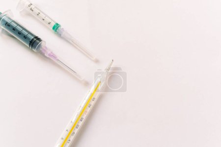 Photo for Thermometer, syringe, Concept of autumn common cold, covid or flu - Royalty Free Image