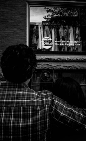 Téléchargez les photos : Plan vertical d'un couple devant un magasin de vêtements à Vancouver, Canada - en image libre de droit