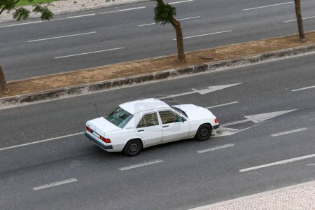 Photo for A white Mercedes 190D driving on the streets of Lisbon - Royalty Free Image