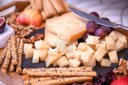 Photo for A closeup shot of grapes, walnuts, and sliced cheese as appetizers - Royalty Free Image