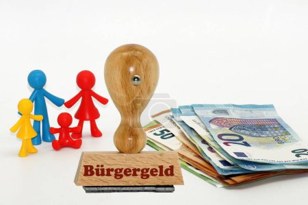 Photo for A wooden rubber stamp with Euro bills and family icon in the background - Royalty Free Image