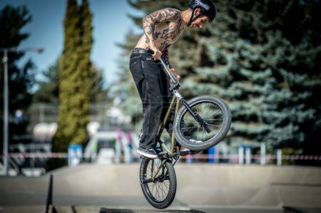Photo for A young man jumping on a bike during the BMX race event in Skate park in Kosice - Royalty Free Image
