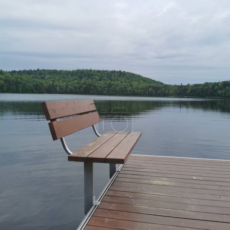 Foto de Una hermosa vista de un banco cerca del lago - Imagen libre de derechos