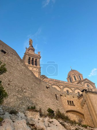Téléchargez les photos : Vue verticale basse de Notre Dame de la Garde par une journée ensoleillée, Marseille, France - en image libre de droit
