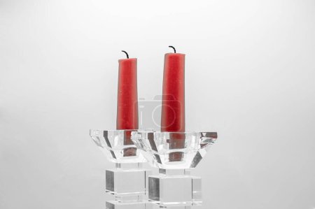Photo for A closeup of two red candles in clear glass candelabras - Royalty Free Image