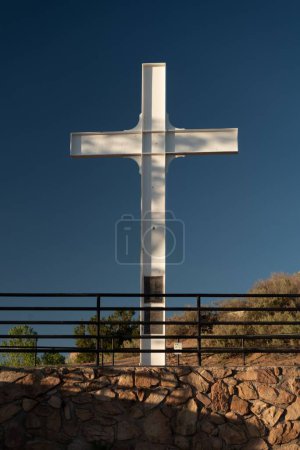 Photo for A vertical shot of the Cross of the Martyrs against a blue sky on the hilltop in Santa Fe, New Mexico - Royalty Free Image