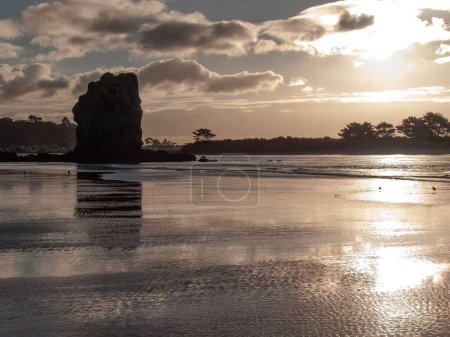 Photo for A now historic photo showing the Avon Estuary and Shag Rock before the earthquake, silhouetted in the afternoon sun. Christchurch, New Zealand - Royalty Free Image