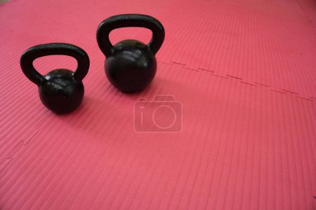 Photo for The fitness kettle bells on a red carpet - Royalty Free Image