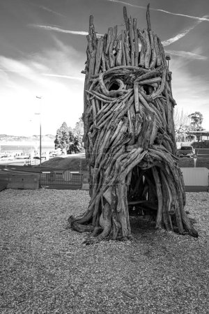Photo for A grayscale vertical shot of Wood statue in the French Flottins Evian village - Royalty Free Image