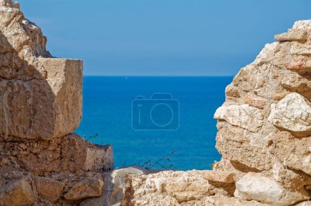 Photo for A beautiful view of the ocean through a hole in a stone wall - Royalty Free Image