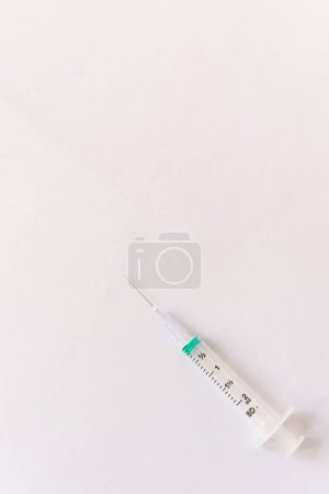 Photo for Syringe on a white table prepared for injection in hospital - Royalty Free Image