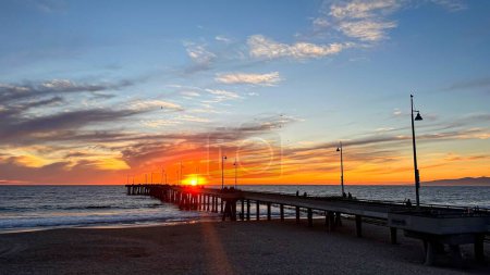 Photo for Colorful sunset lights up the beach, pier and ocean in Los Angeles - Royalty Free Image