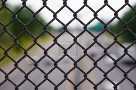 Photo for The close-up view of a silver wire fence creates a patterned background - Royalty Free Image