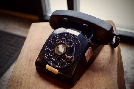 Photo for A closeup of old vintage black telephone in coffee shop in Pittsburgh, Pennsylvania - Royalty Free Image