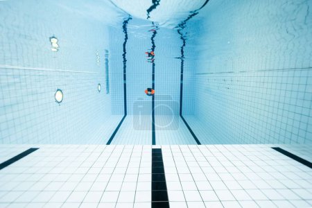 Téléchargez les photos : Une plongée humaine dans une piscine claire et bien conçue - en image libre de droit