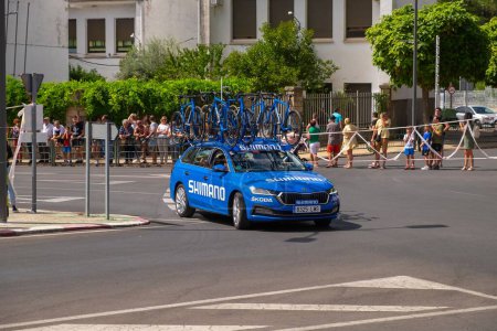 Photo for The vehicles of the cyclists carrying many bicycles on the roof during the cycling tour of Spain - Royalty Free Image