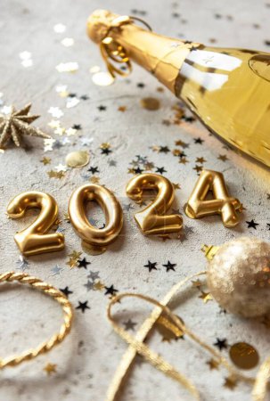 Photo for Vertical Golden color palette photo with new year 2024 numbers surrounded by confetti and decorations - Royalty Free Image